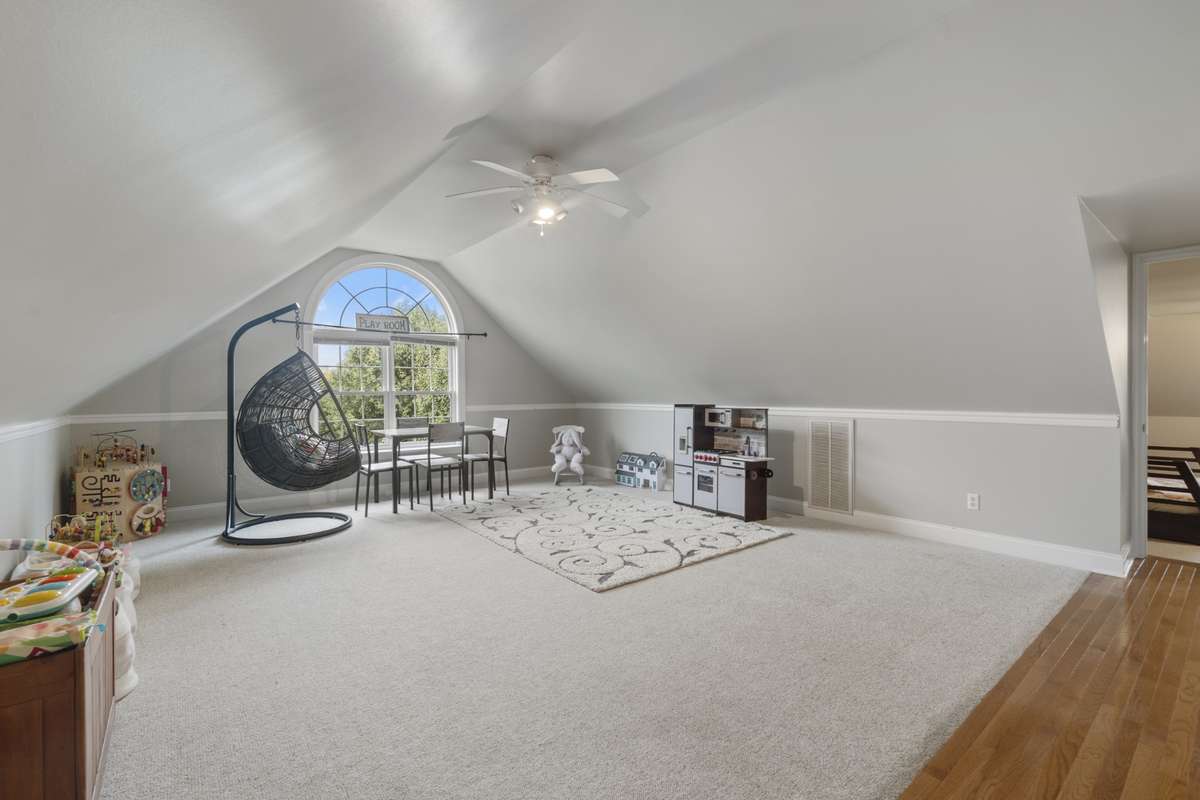 Upstairs bonus room with 1/2 bath makes a great playroom.