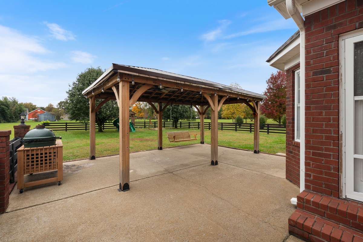 Just outside the kitchen this covered patio area is the perfect spot for summer grilling.