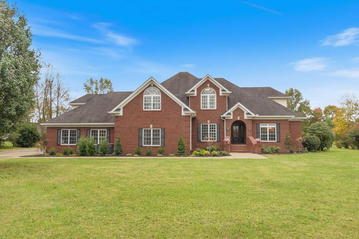 Impressive all-brick residence with classic architectural detail, a grand arched front entrance and beautifully landscaped offering a private, estate-style setting.