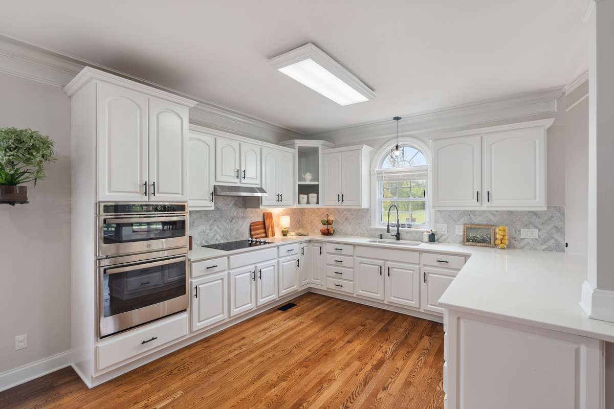 Stainless steel appliances and electric smooth surface cooktop.