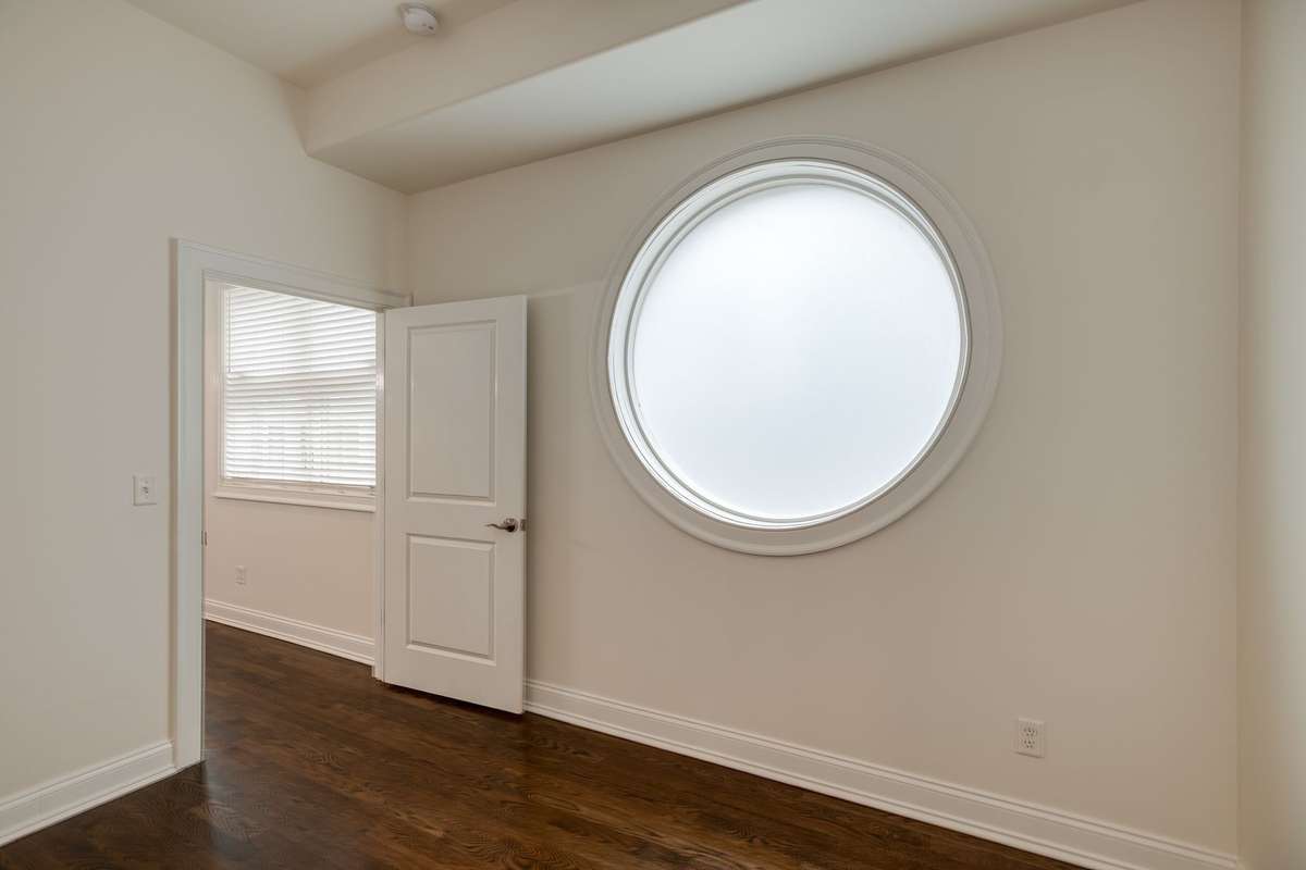 This main level bedroom or office space has direct access to the full bath with walk-in tile surround shower.
