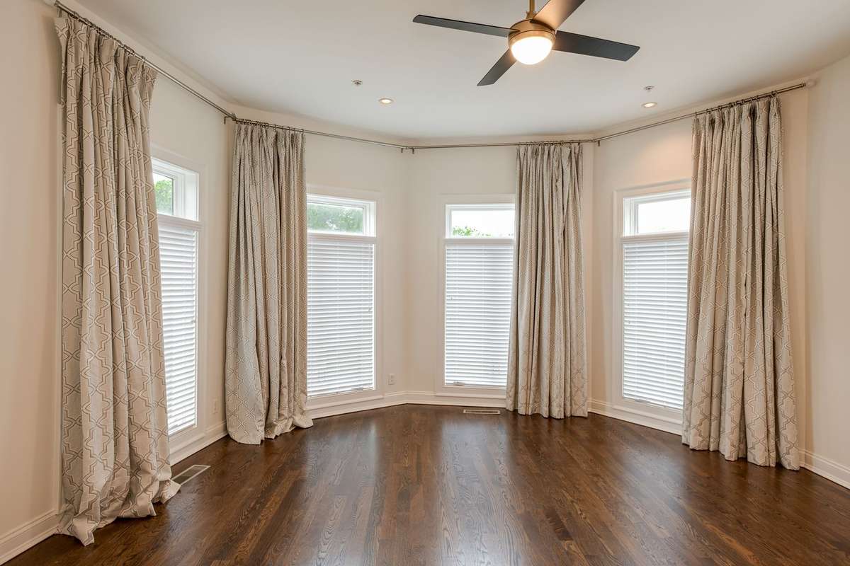 The Primary Bedroom is elevated with oversized windows and high ceilings providing an abundance of natural light giving it a spacious yet tranquil feel.