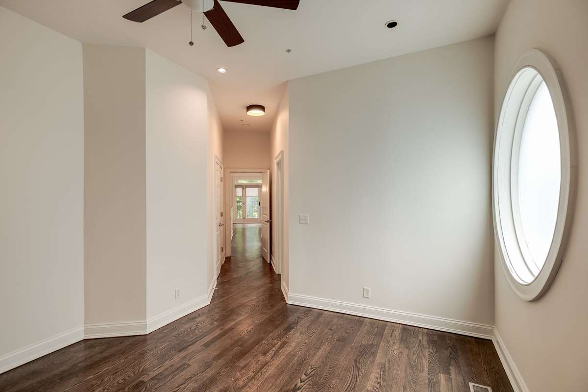 The third bedroom located on the second floor offers a serene retreat for guests or family members, featuring a private covered balcony, a full bath with a walk-in shower, contemporary vanity with ample counter space & custom designed walk-in closet.
