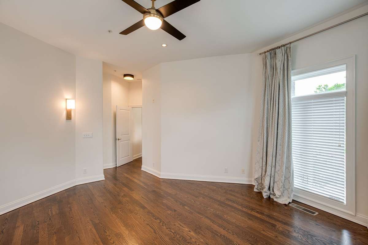 The Primary Bedroom is elevated with oversized windows and high ceilings providing an abundance of natural light giving it a spacious yet tranquil feel.