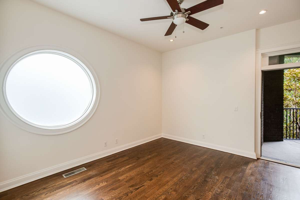 The third bedroom located on the second floor offers a serene retreat for guests or family members, featuring a private covered balcony, a full bath with a walk-in shower, contemporary vanity with ample counter space & custom designed walk-in closet.