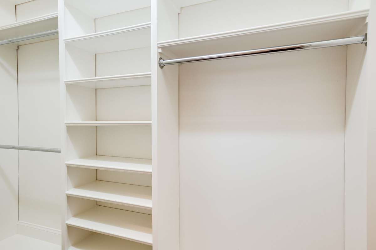 Bedroom 3, custom designed walk-in closet with built in shelves and various hanging rods.