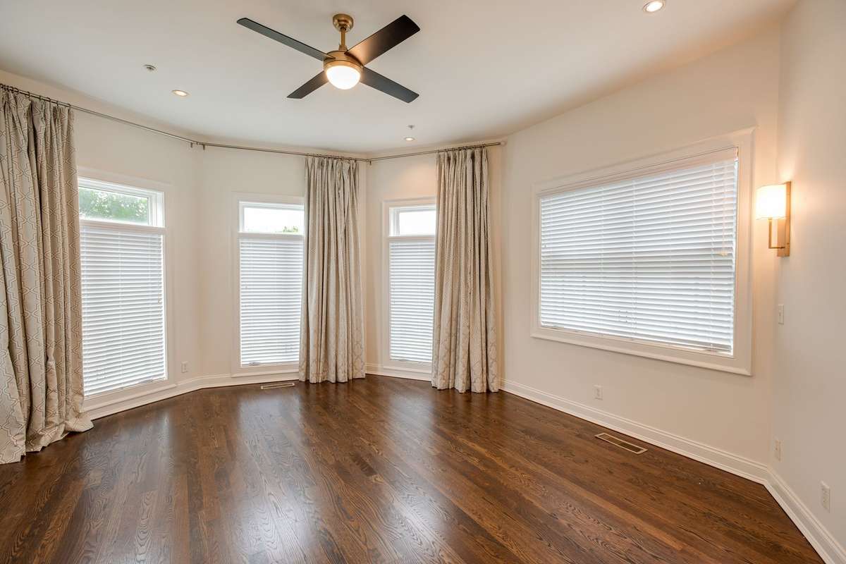 The Primary Bedroom is elevated with oversized windows and high ceilings providing an abundance of natural light giving it a spacious yet tranquil feel.