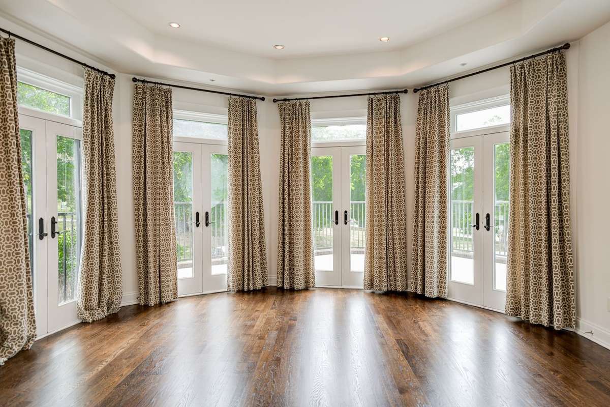 Love this Living Room with 4 working French Doors leading to the front patio with a view of the large green park across the street.