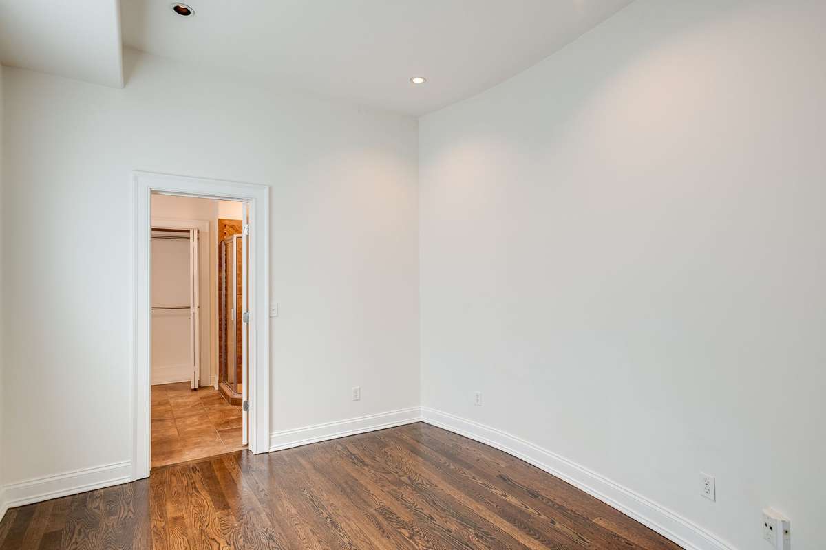 This main level bedroom or office space has direct access to the full bath with walk-in tile surround shower.