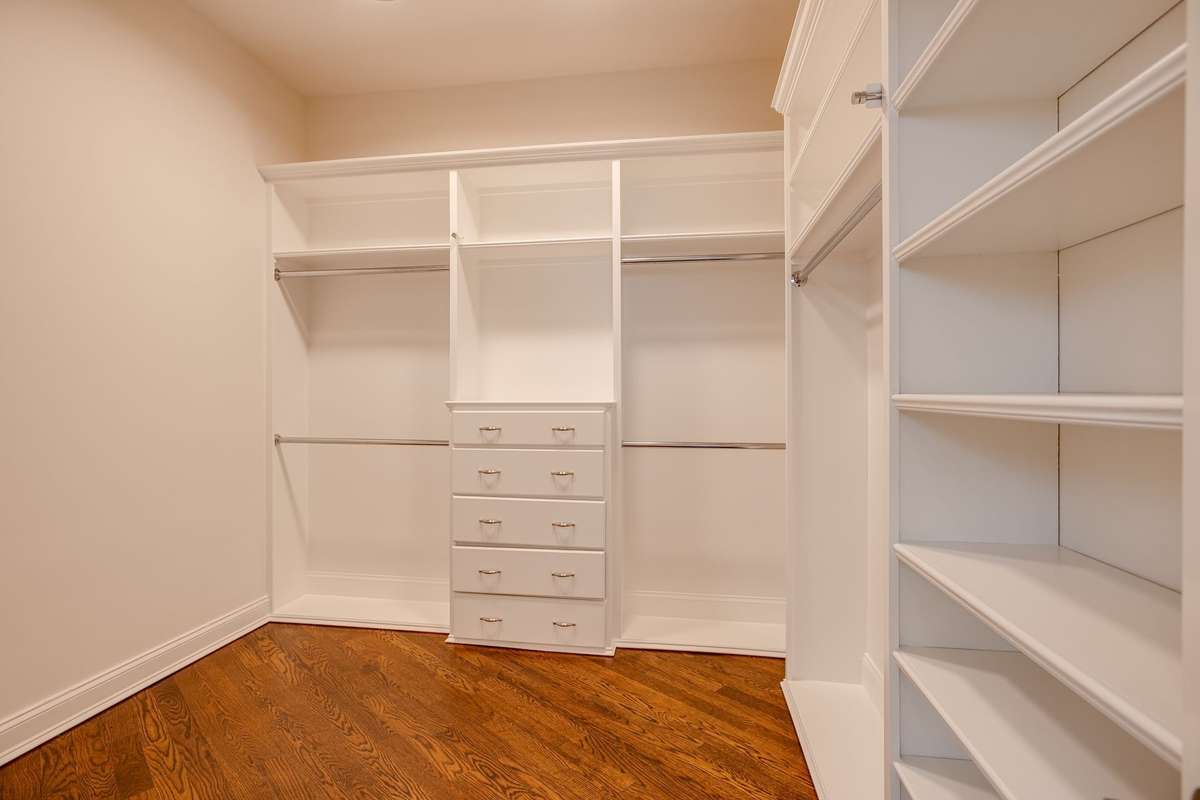 The Primary Ensuite custom designed walk-in closets maximizes the space and organization as well as accommodating an entire wardrobe, making items more visible and accessible.