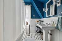 The updated bathroom is a delightful blend of sophisticated vintage charm.