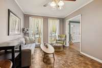 Relax and enjoy the brightness of the tall windows and the breeze of the ceiling fan.