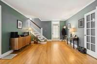 Extra light filters into the room through the transom window atop the back door. The den is just to your right through glass doors!