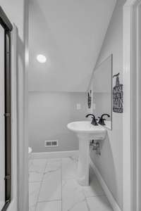 Bathroom upstairs with bonus room.