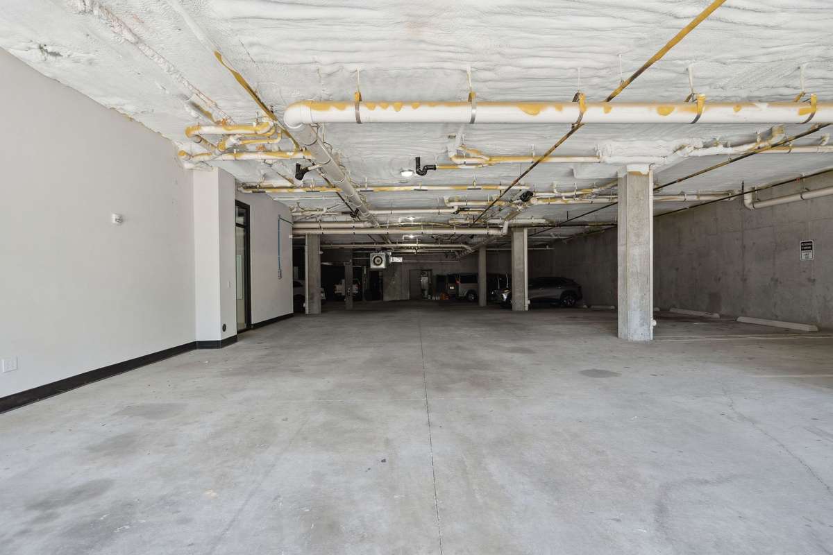 Ground floor parking in a secure gated entry garage. Security cameras in use through the building.