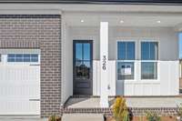 Relaxing front covered porch with beautiful 8-foot grand entry door