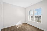 2nd bedroom at front of the house with two windows for natural light and has attached full bath and walk in closet.