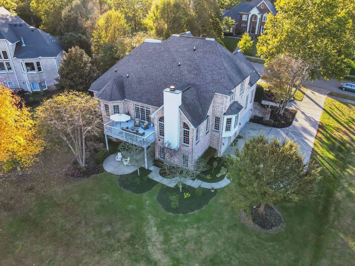Shows off the home’s striking rooflines, deck, and large backyard with room for a pool or play.