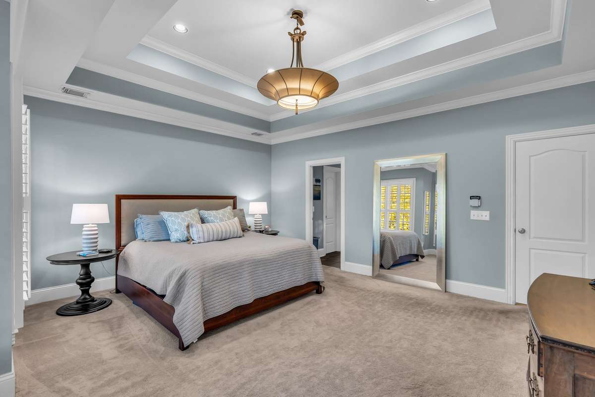 Elegant retreat with crown molding, recessed lighting, and private access to the luxurious bath.