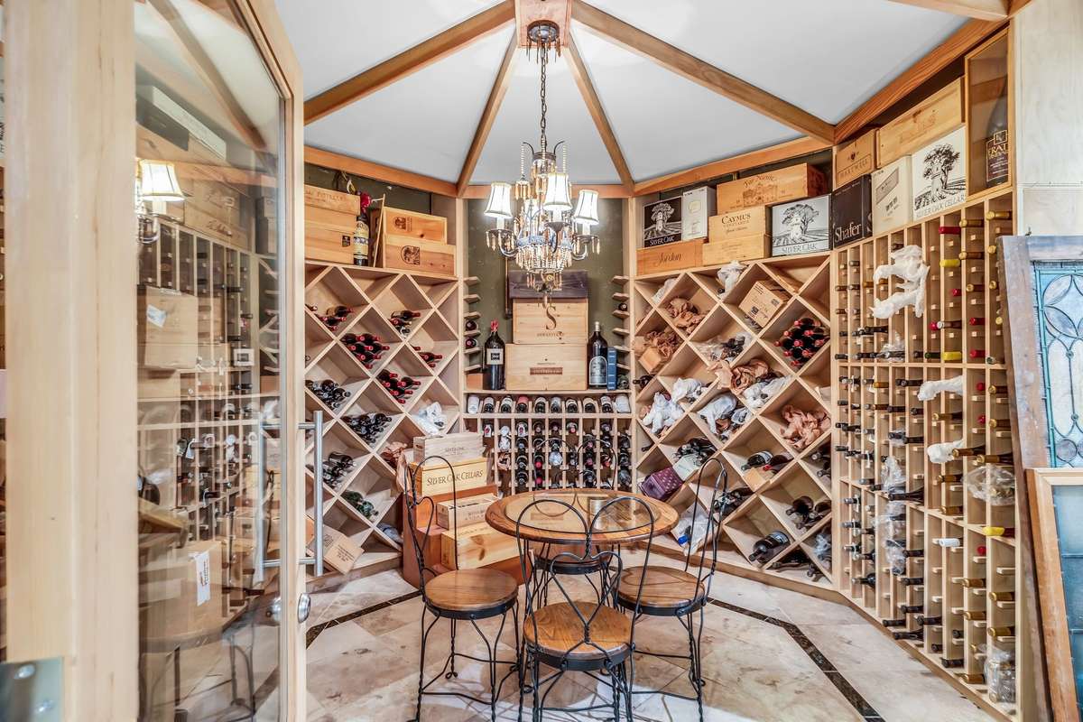 Climate-controlled wine cellar with custom wood racks and storage for an impressive collection.
