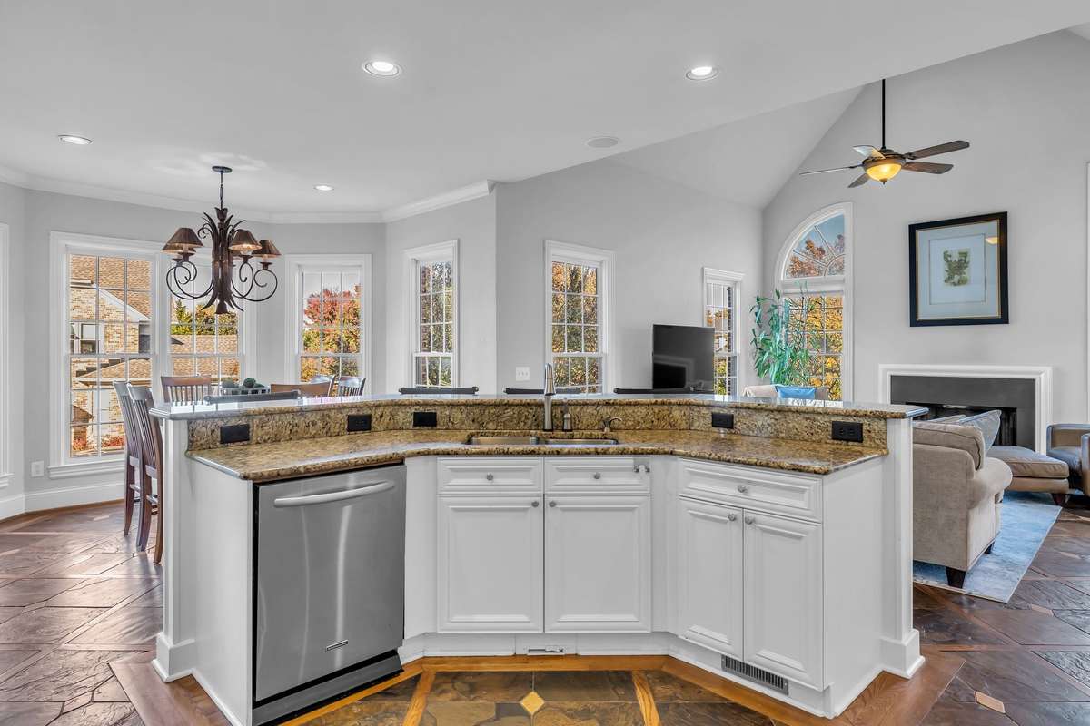 Expansive island with double sink and breakfast bar seating—both functional and elegant.