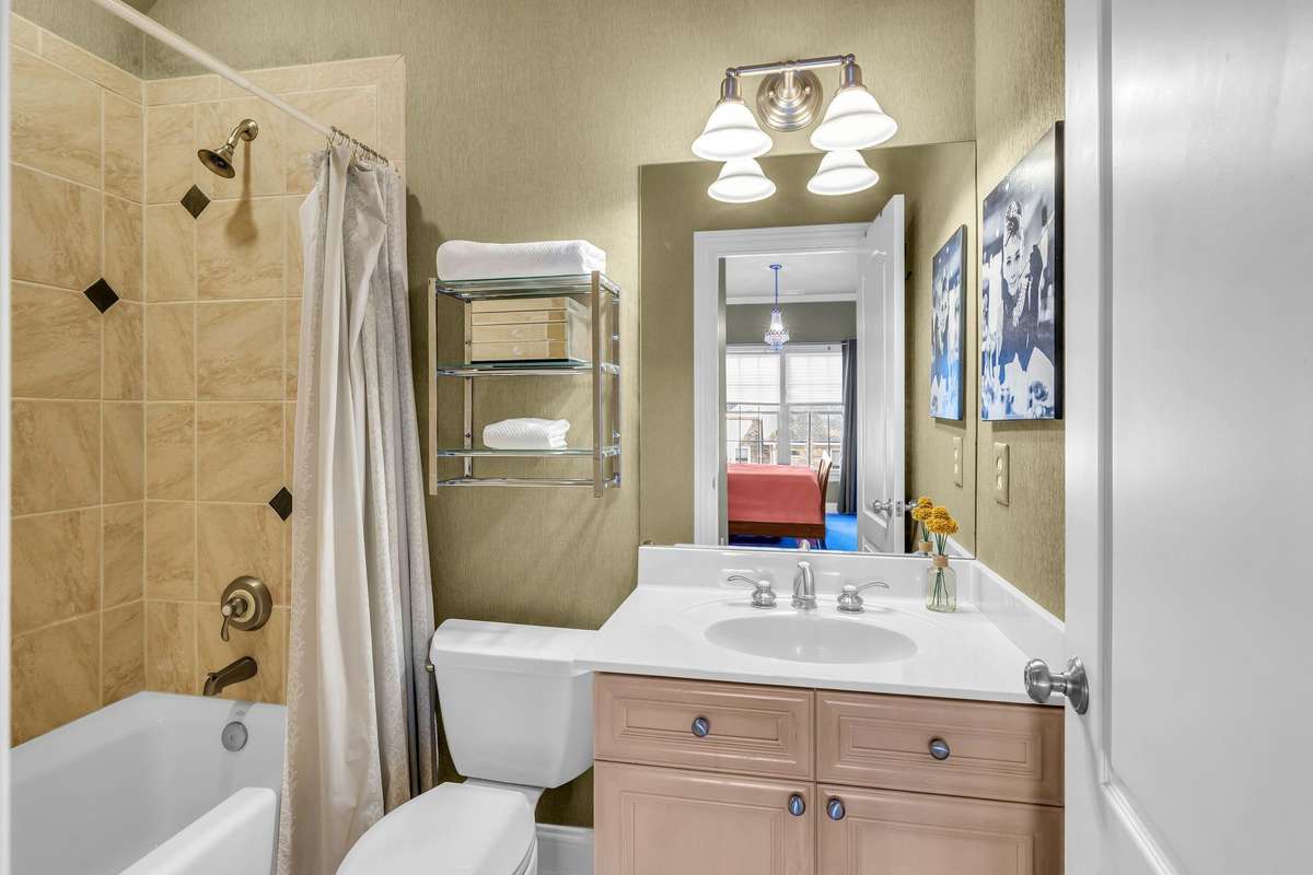Beautifully tiled bath with soaking tub and some updated fixtures for a refined touch.