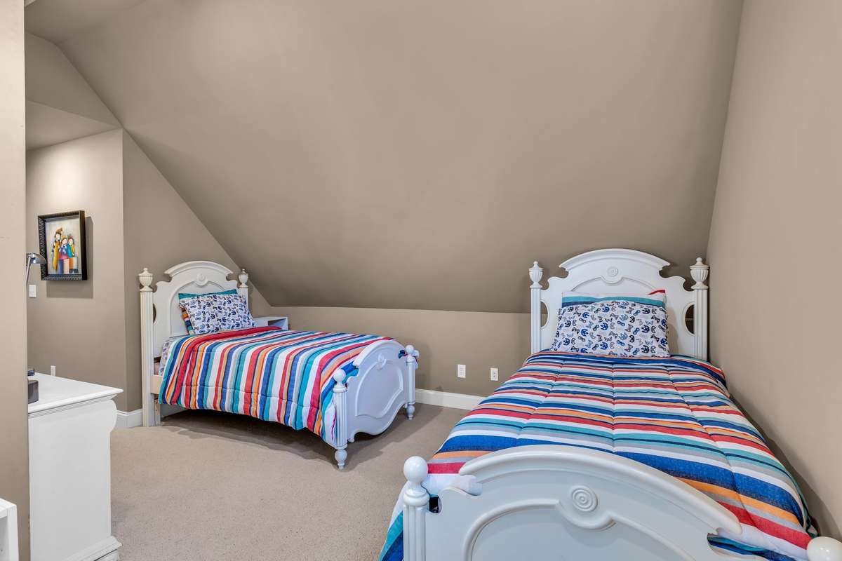 Spacious design offers flexibility for twin beds, office, or creative space.