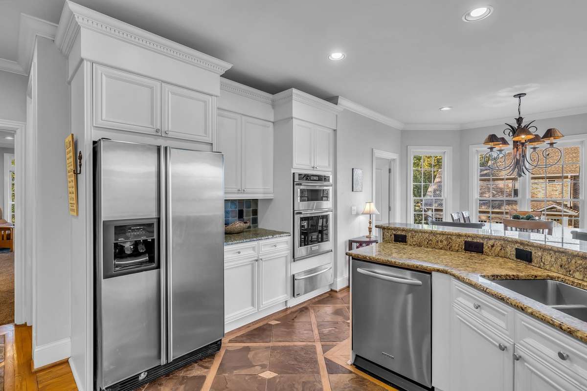Stainless Kitchen-aid appliances include double ovens, refrigerator, dishwasher and warming drawer.