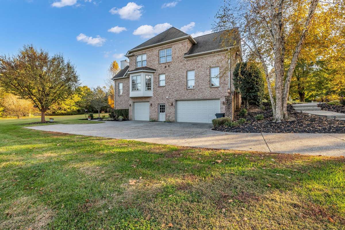 Elevated outdoor space with sunshine, shade, and plenty of room to entertain with a Two Car Garage that is extended inside and a One Car Garage with a Pedestrian Door leading in.  Garage can fit 4 vehicles.  Plenty of more storage in garage as well.