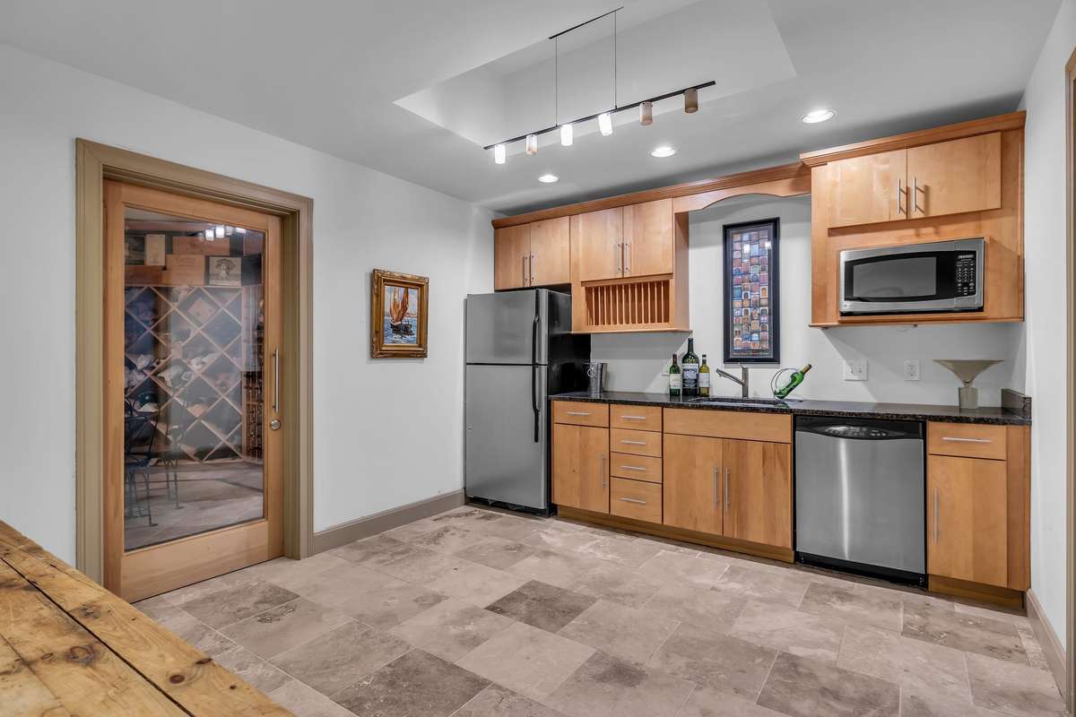 Well-appointed lower-level kitchenette with stainless appliances and abundant storage—perfect for entertaining or in-law suite.
