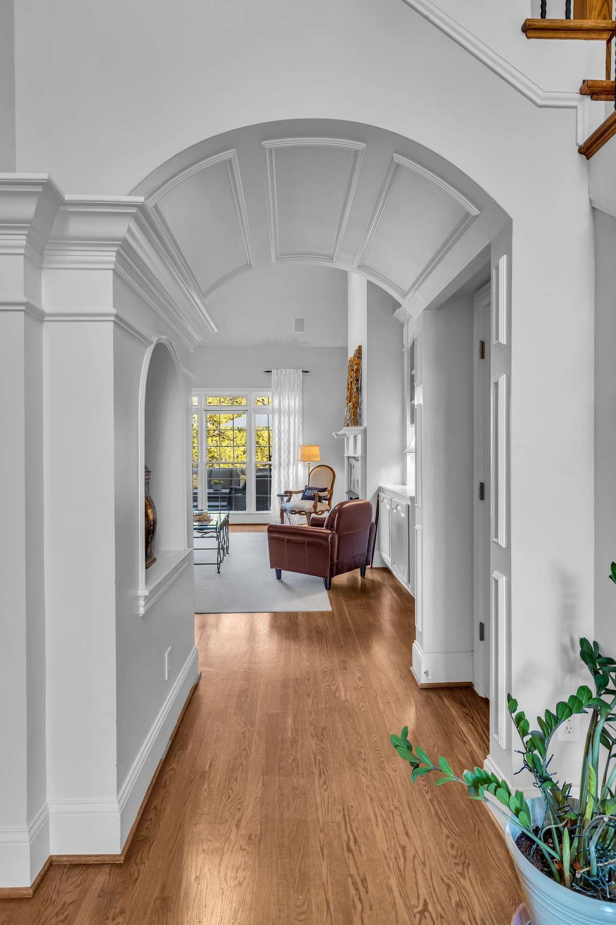 A beautiful arched passageway opens to the living room, showcasing craftsmanship and architectural flow.