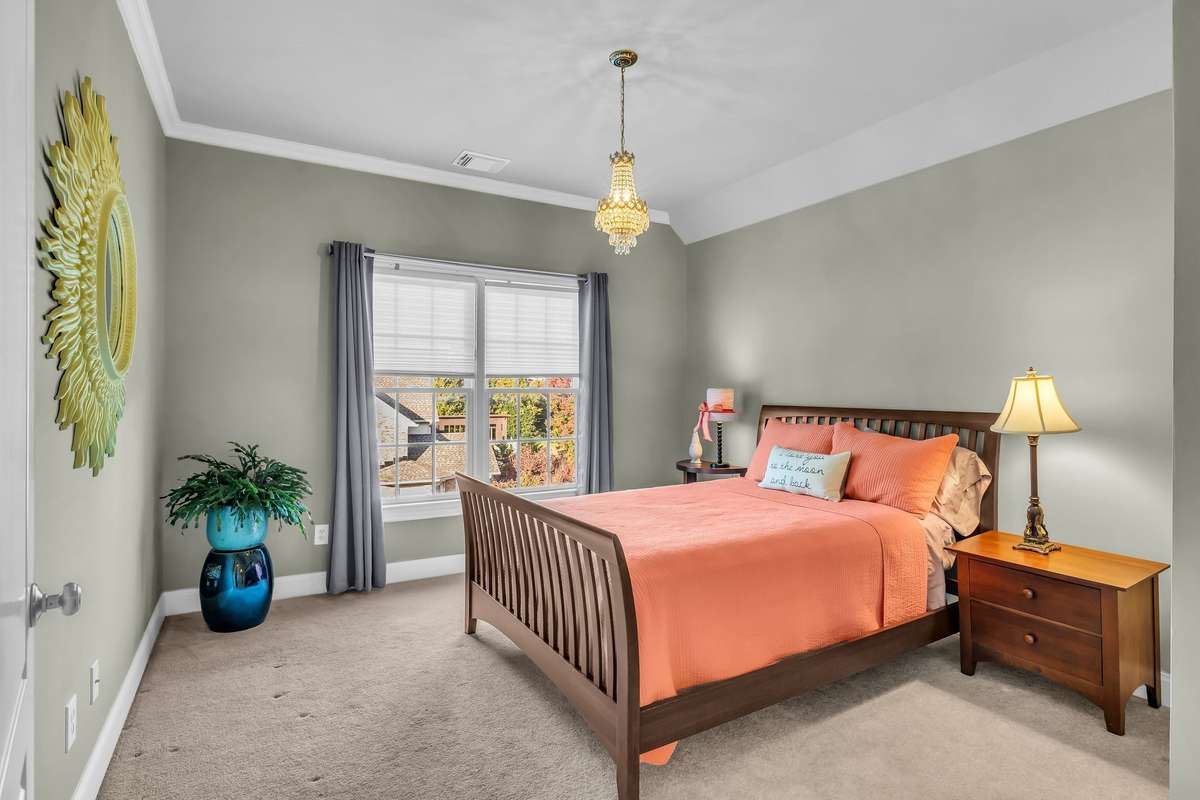Inviting guest suite with large window and walk-in closet with private bath.
