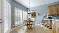 Kitchen eating area - ALL windows have Plantation Shutters - look at the dog feeding station in the corner!