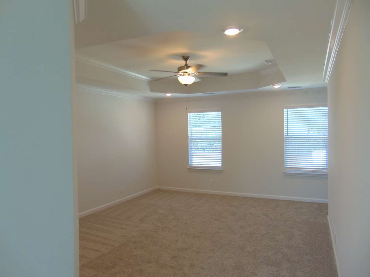The primary bedroom, is on the second floor and has tray ceilings