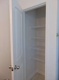 The linen closet within the second bathroom