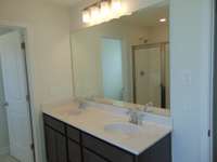 The primary bathroom has a soak in tub and shower, as well as two sinks.