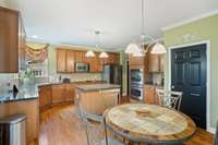 Lots of countertop space and cabinets. . . double ovens, built-in microwave, cooktop, dishwasher and refrigerator. Door leads down to walk-out basement