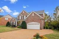 Driveway has an extra parking area to the side. Garage is 3 car tandem (2 cars deep on one side).  Newer roof and gutters.