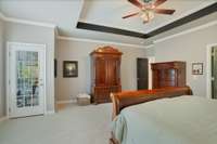 Another view of the primary suite with exterior door that leads out to covered deck