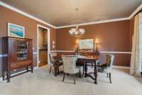 Formal dining room with crown molding, chair rail and lots of room for serving table and more.  Overlooks the front yard.