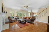 Open floorplan great for entertaining and family time!  Fresh paint, wood floors, ceiling fan, fireplace and windows overlooking mature trees