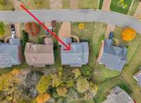 Aerial view . . . lot extends into the treed area.  Notice the extra driveway parking space!