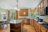 Exterior door in kitchen leads to covered wood deck.