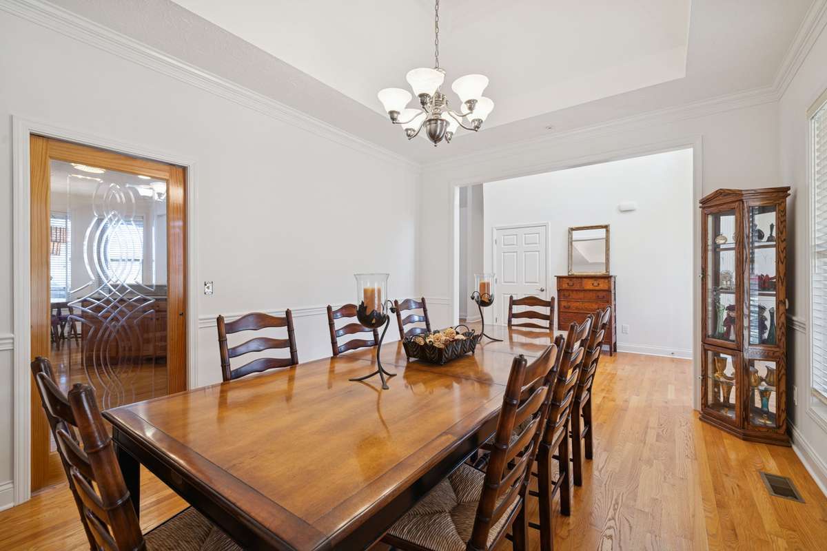 Formal Dining is separated from Kitchen by beautiful custom pocket door with etched glass.