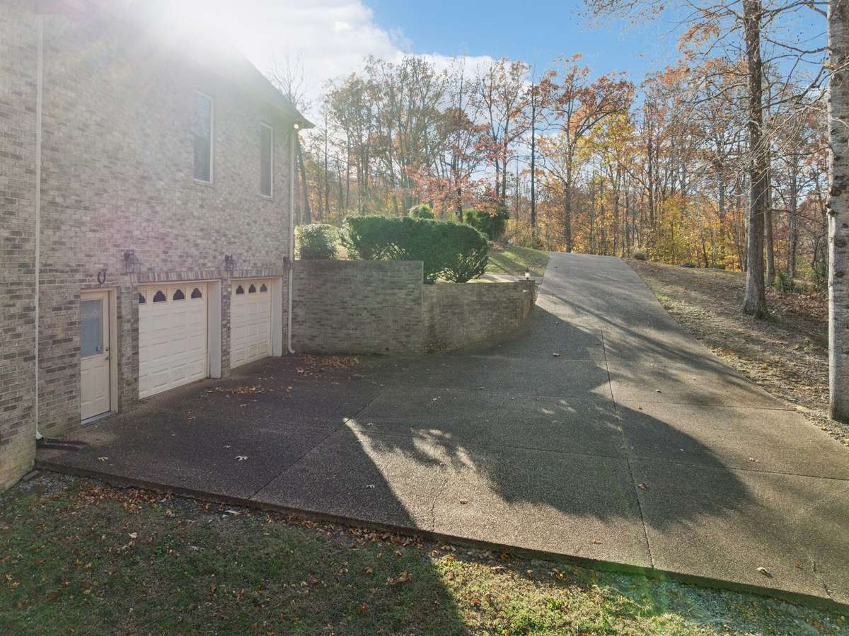 TONS of parking and turn around area. Big garage and workshop! (Not pictured)