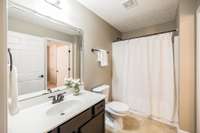Stepping into this crisp clean guest bath, you'll find it very spacious and private.