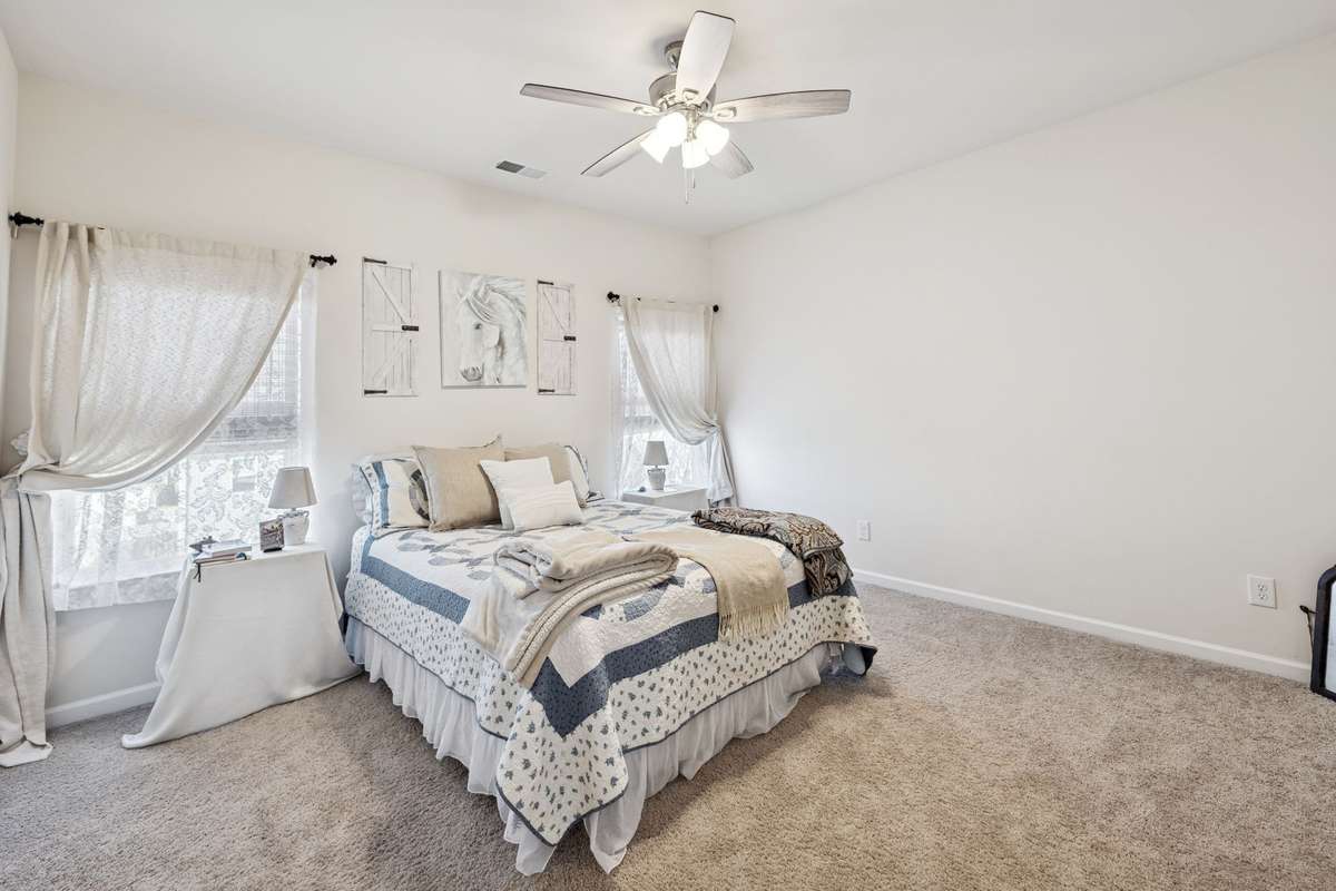 Large primary bedroom with symmetrical windows framing your bed.  2605 Sherman Way Columbia TN 38401