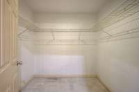 Primary walk in closet plenty of space for all your closet needs.