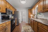 Kitchen with attached laundry/storage room.