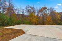 Large concreted area in front of the garage.